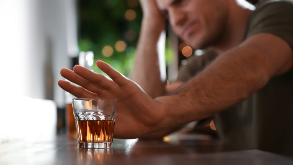 man refusing alcoholism