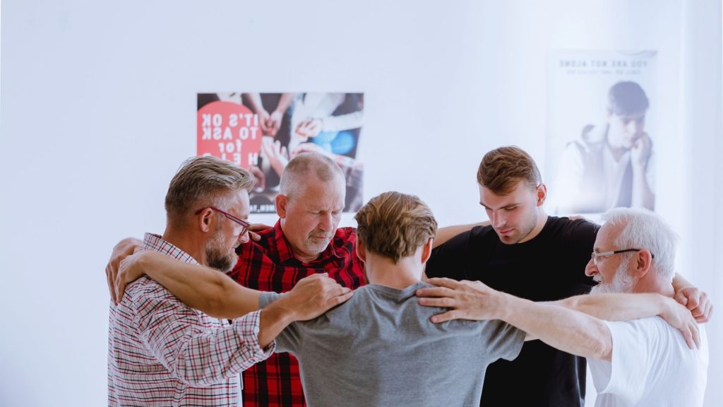 men participating in group prayer
